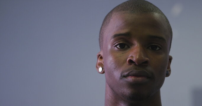 Portrait of a biracial modern male dancer, wearing black clothes, looking at the camera