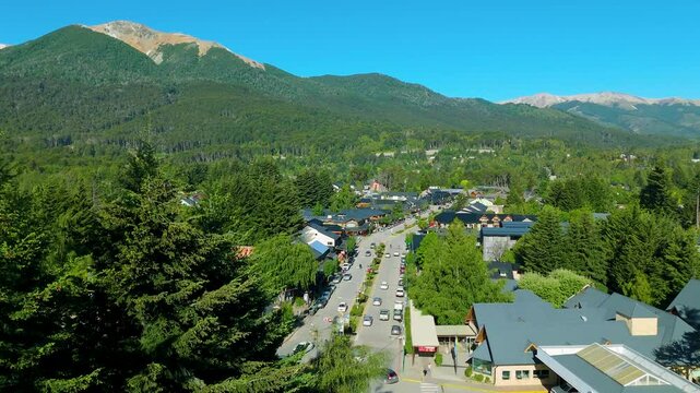Scenic aerial view of Villa La Angostura's main urban area featuring Arrayanes Avenue. Nestled in Patagonia, Argentina, the image captures the charming blend of urban development and surrounding.