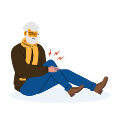 Senior man experiencing knee pain while sitting on the floor during winter
