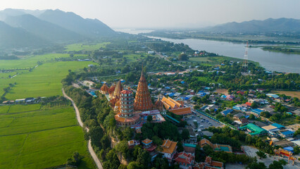 Aerial of  Wat Tham Suea buddhist temple in Kanchanaburi Thailand at sunset