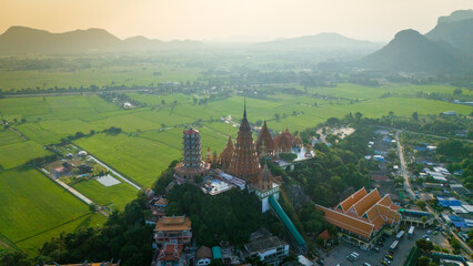 Aerial of  Wat Tham Suea buddhist temple in Kanchanaburi Thailand at sunset