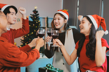 Group of young Asian man and women as friends having fun at a New Year's celebration, holding gift...
