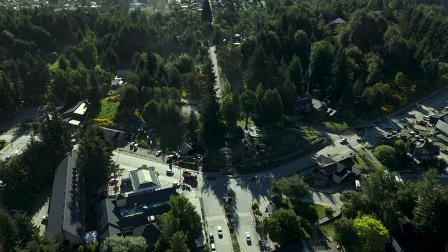 Scenic aerial view of Villa La Angostura's main urban area featuring Arrayanes Avenue. Nestled in Patagonia, Argentina, the image captures the charming blend of urban development and surrounding.