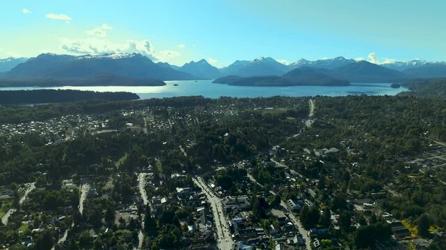 Scenic aerial view of Villa La Angostura's main urban area featuring Arrayanes Avenue. Nestled in Patagonia, Argentina, the image captures the charming blend of urban development and surrounding.