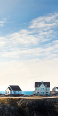 Fototapeta premium Coastal homes under a clear blue sky with gentle clouds