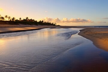 Fototapeta premium Serene Tropical Beach with Calm Waves During Peaceful Sunset