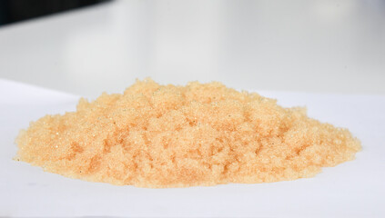 Microbeads of ion-exchange resin (ion-exchange polymer) Wet resin filtration for water purification on white background