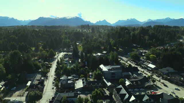 Scenic aerial view of Villa La Angostura's main urban area featuring Arrayanes Avenue. Nestled in Patagonia, Argentina, the image captures the charming blend of urban development and surrounding.