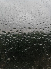 Raindrops on the window glass of a dark night