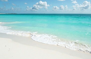 Gentle waves roll onto a pristine shore under a clear blue sky, creating a serene tropical atmosphere perfect for relaxation. Generative AI