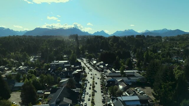 Scenic aerial view of Villa La Angostura's main urban area featuring Arrayanes Avenue. Nestled in Patagonia, Argentina, the image captures the charming blend of urban development and surrounding.