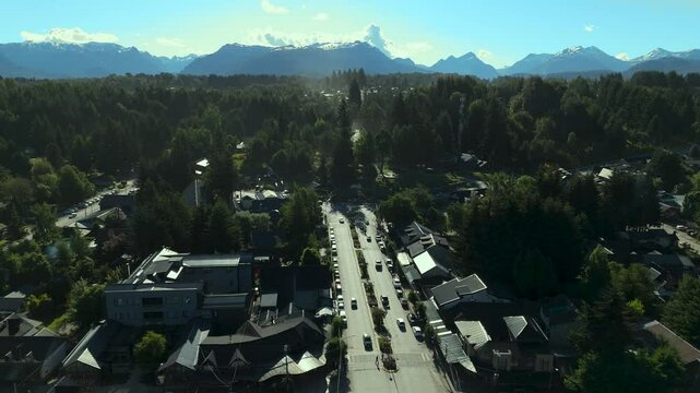Scenic aerial view of Villa La Angostura's main urban area featuring Arrayanes Avenue. Nestled in Patagonia, Argentina, the image captures the charming blend of urban development and surrounding.