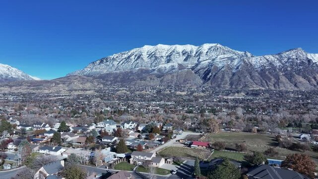 Aerial Residential valley mountain snow Orem Utah 1. Orem city, variety of stores businesses. Urban economy Malls, stores, residential neighborhoods, parks. High desert valley. Snow covered winter.