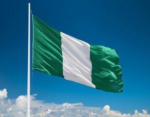 Nigeria flag waving in the wind against a blue sky background