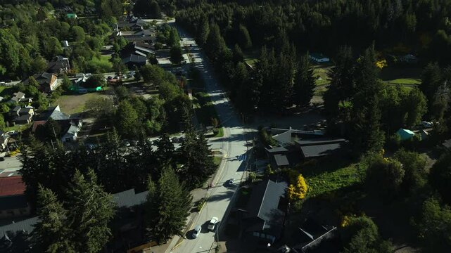 Scenic aerial view of Villa La Angostura's main urban area featuring Arrayanes Avenue. Nestled in Patagonia, Argentina, the image captures the charming blend of urban development and surrounding.