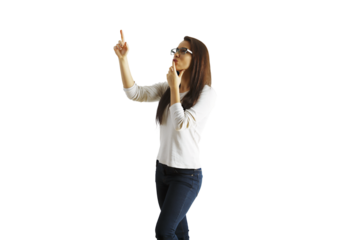 Young woman wearing glasses and casual attire, standing in a thoughtful pose with one hand on chin and pointing upward, isolated on white background