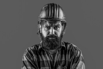 Fototapeta premium Building, industry. Builder in hard hat, foreman or repairman in the helmet. Black and white