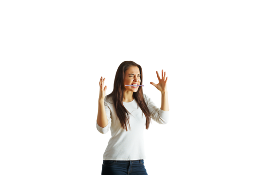 Woman showing frustration with hands raised, pen in mouth, wearing casual clothes, isolated on white background, concept of stress - Powered by Adobe
