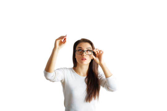 Portrait of a young woman adjusting her glasses and holding a pen, wearing a white shirt, on an isolated white background, concept of thinking