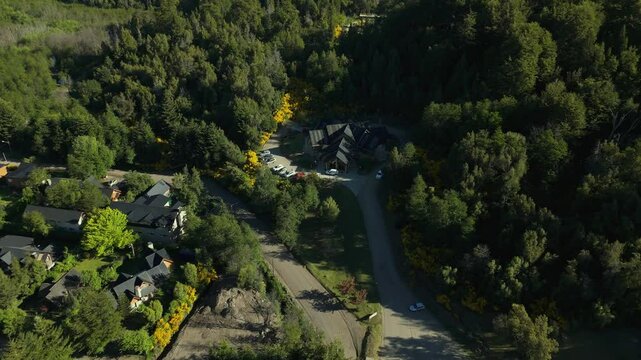 Scenic aerial view of Villa La Angostura's main urban area featuring Arrayanes Avenue. Nestled in Patagonia, Argentina, the image captures the charming blend of urban development and surrounding.