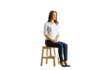 A young woman sitting on a wooden stool wearing a casual outfit, isolated on a white background. Concept of simplicity, minimalism, and lifestyle