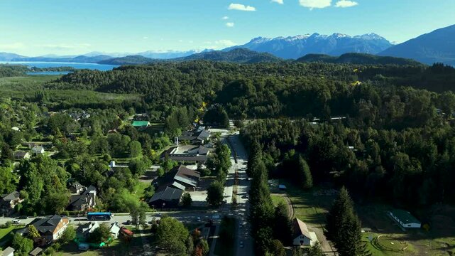 Scenic aerial view of Villa La Angostura's main urban area featuring Arrayanes Avenue. Nestled in Patagonia, Argentina, the image captures the charming blend of urban development and surrounding.