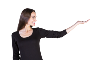 Smiling woman inlong-sleeve top pointing or presenting with an extended hand, isolated on a clean white background. Concept of presentation