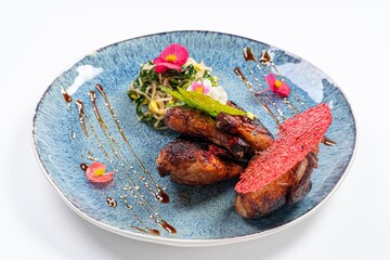 Fried Chicken with Greens on a Plate Against a White Background