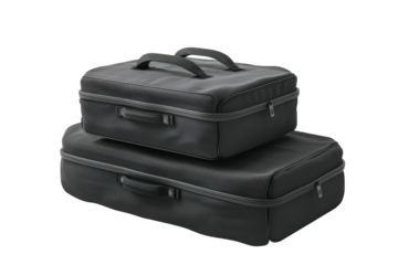 Stylish black travel suitcases stacked on each other, perfect for organized journeys