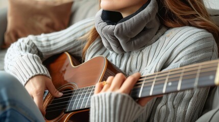 Fototapeta premium A person playing an acoustic guitar with a neck support cushion, symbolizing music and relaxation, isolated on white background