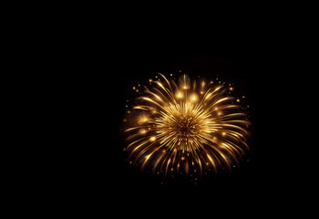 Fototapeta premium A breathtaking burst of golden fireworks explodes against a dark night sky, radiating light and brilliance. The intricate details and vibrant colors create a stunning visual spectacle.