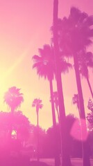 Obraz premium A dreamy scene of palm trees silhouetted against a vibrant pink sunset.