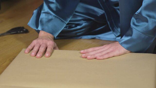 Female hands sealing a package