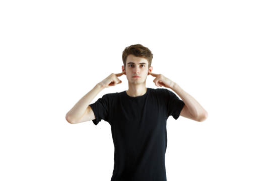 Young man covering ears with fingers, wearing aT-shirt, on an isolated white background. Concept of ignoring, blocking, or refusal
