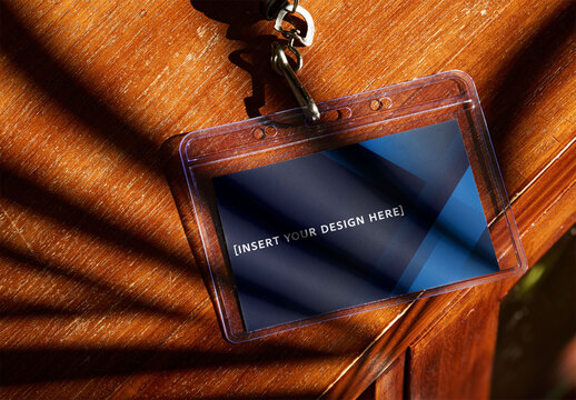 Transparent Plastic Access Pass Placed on Wooden Surface With Shadows. PSD Mockup ready to use.