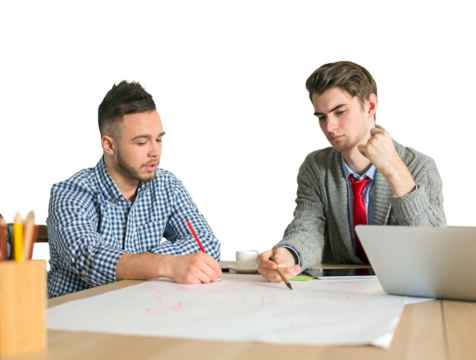Two young men working together on a project at a desk, one writing on paper and the other analyzing. White background, concept of teamwork