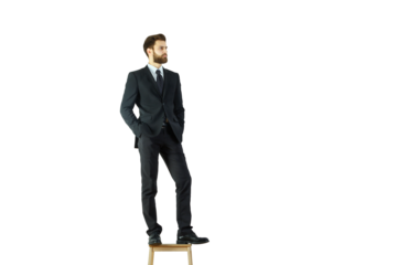 A well-dressed man in a suit stands on a wooden stool, hands in pockets, looking away, isolated on a white background, concept of leadership