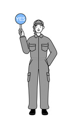 A mechanic woman in coveralls holding a maru placard that shows the correct answer.