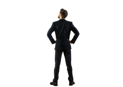 A man in a dark suit viewed from behind, standing with hands on hips, isolated on a clean white background. Concept of confidence, business, and leadership