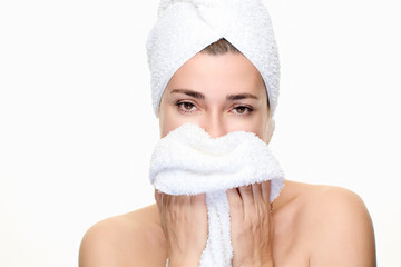 Relaxed woman with towel indulges in spa skincare routine