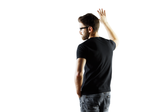 Male in casual attire, t-shirt and jeans, standing with back turned and hand raised, isolated on a white background. Concept of casual style