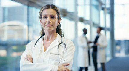 Woman, doctor and portrait with confidence for medical service, healthcare career or job at hospital. Female person, health professional or cardiologist with stethoscope or arms crossed at clinic