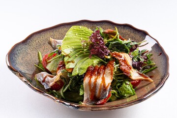 Eel Salad with Greens and Sauce on a White Background