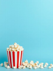 there is a popcorn bowl with popcorn scattered on the ground.