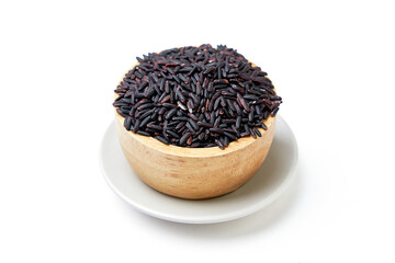 Riceberry in wooden bowl isolated on white background. Riceberry (Oryza sativa) is a dark purple glutinous rice that is aromatic, nutritious high.