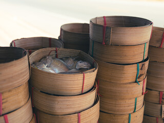 Thai mackerel fish steamed put line up in bamboo basket on sale in the market