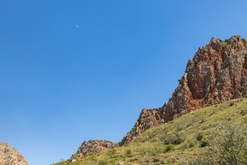 Monastery amid stunning red rocks and lush greenery showcases Armenias natural beauty.