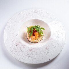 Arugula Salad with Shrimp on a White Plate Against a White Background