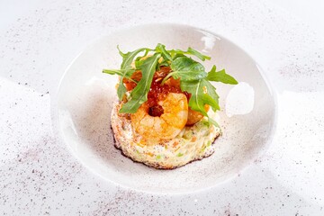 Arugula Salad with Shrimp on a White Plate Against a White Background