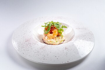 Arugula Salad with Shrimp on a White Plate Against a White Background